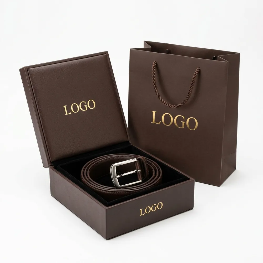 Coiled brown leather belt in an open rigid custom belt box with matching paper shopping bag