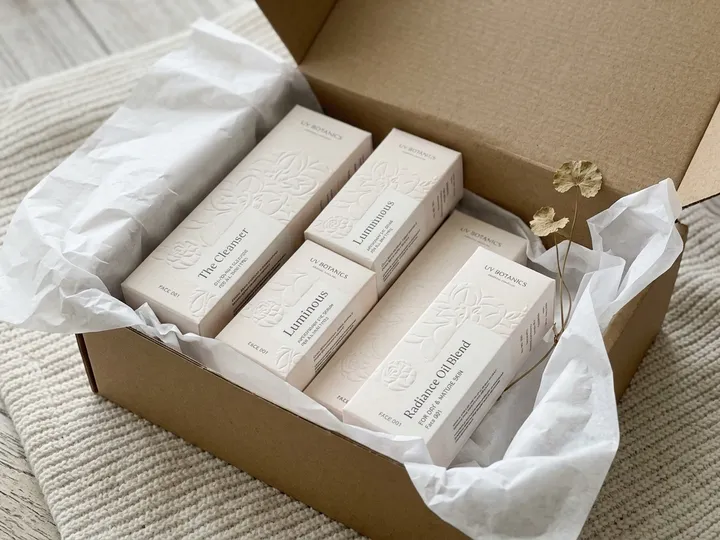 Ivory essential oil cartons arranged inside a corrugated shipping box with tissue