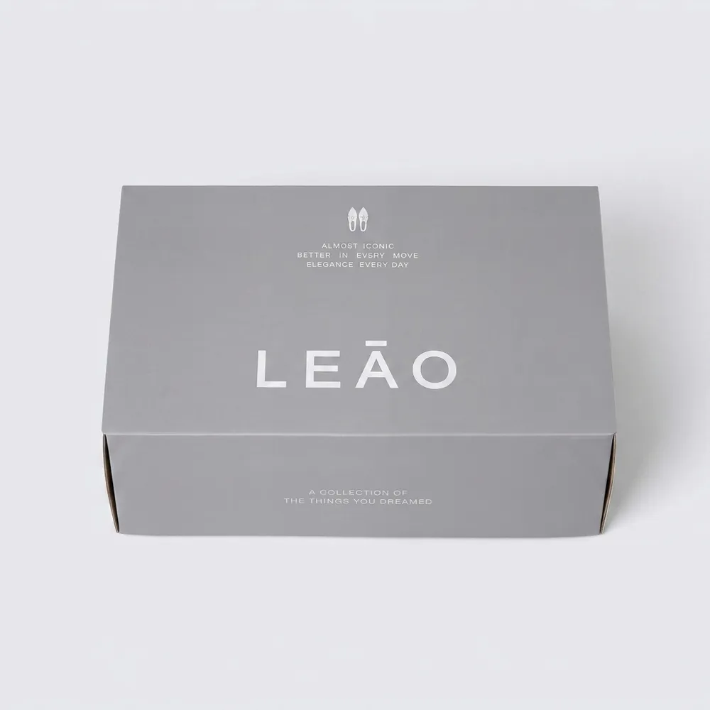 Custom corrugated shoe boxes in gray with silver foil branding and self-locking side construction