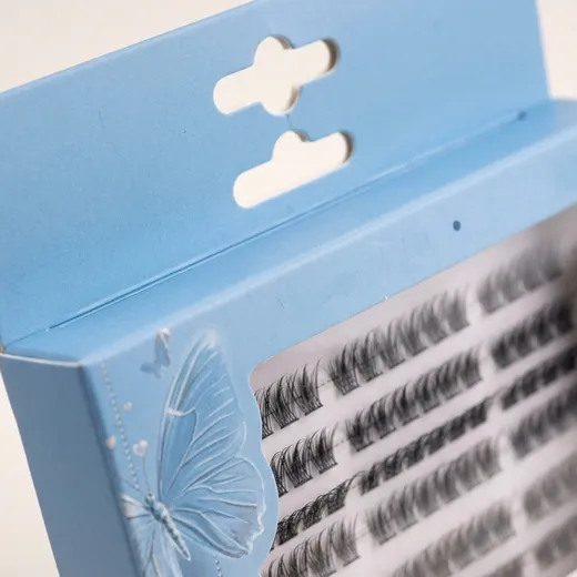 Close-up of two retail hanging slots above the clear PET window on an eyelash carton