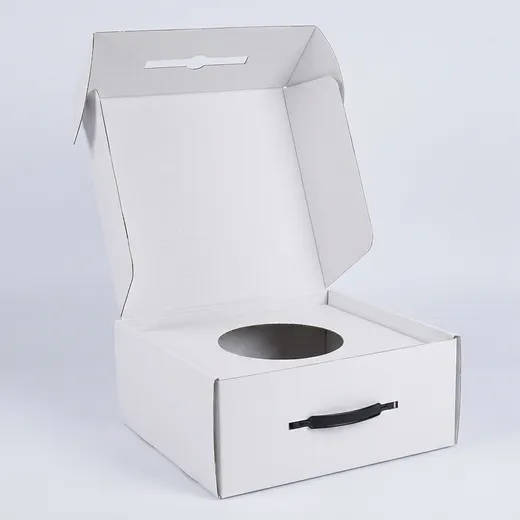 Open white corrugated hat box with hinged lid, side flaps, lid lock slot, circular opening, and black handle