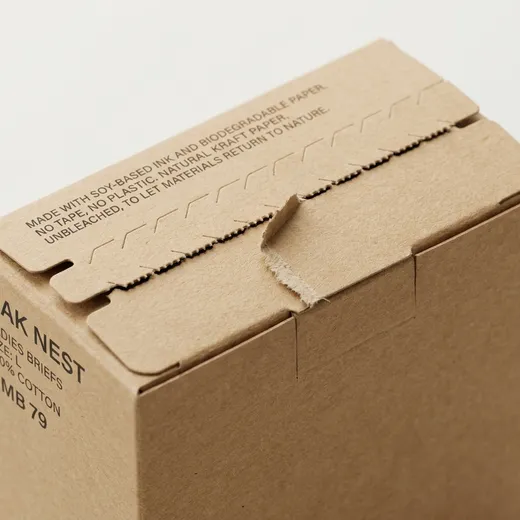 Serrated tear-open line on a compact kraft underwear carton lid