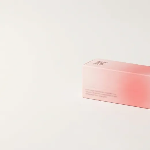 Pink lipstick carton on a white background showing its slim profile