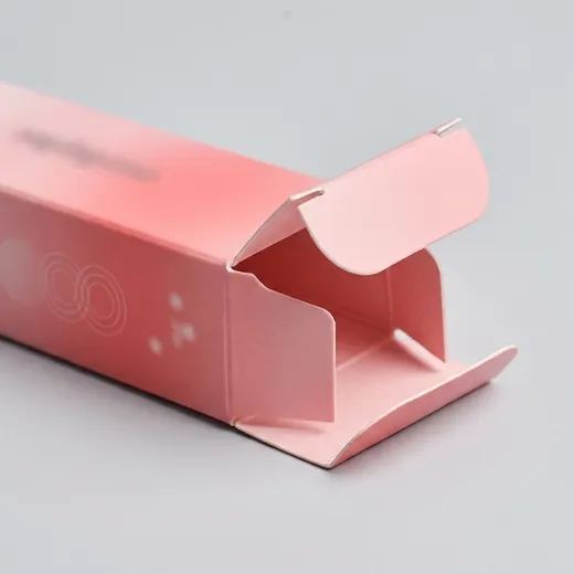 Close view of the tuck closure on a pink lipstick carton