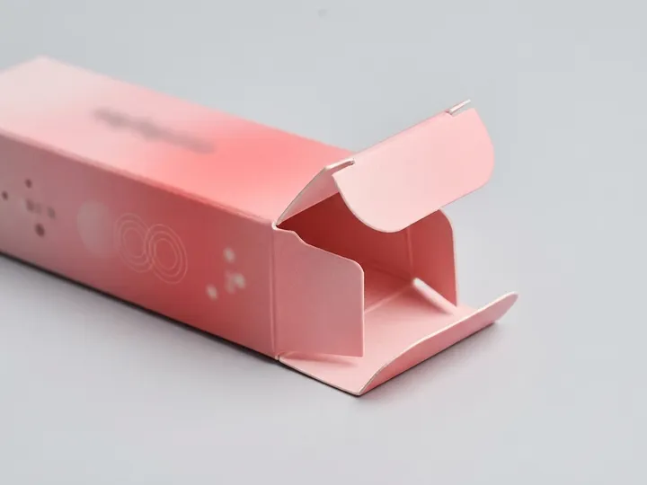 Close view of the tuck closure on a pink lipstick carton