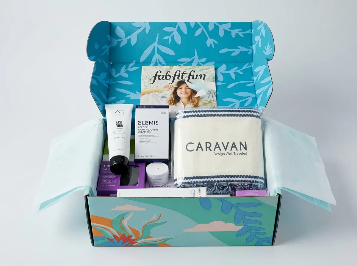 Open custom monthly subscription mailer box with printed lid, side wings, tissue, and assorted products