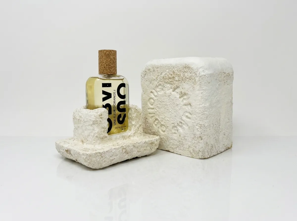 Open mycelium package with a molded base holding a perfume bottle