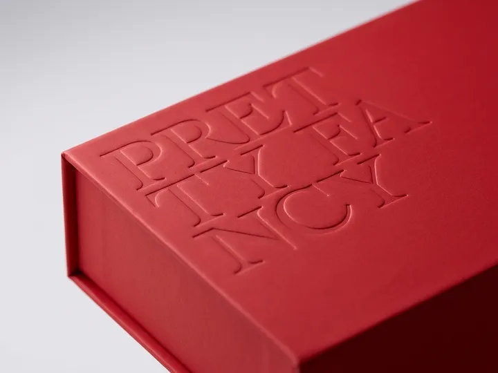 Close view of recessed English lettering on a red soft-touch chocolate gift box lid