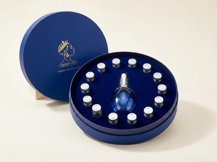 Open custom round rigid PR box holding one central blue bottle and a ring of small vials in flocked EVA