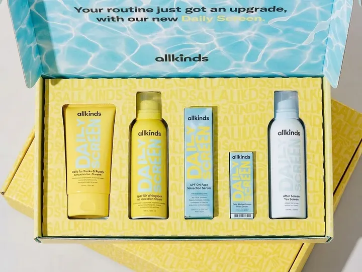 Top view of five skincare containers seated in die-cut openings within an integrated printed corrugated insert