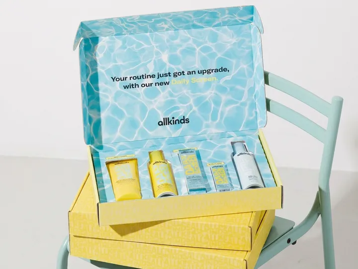 Open skincare ecommerce mailer kit holding five fitted tubes, bottles, and cartons in a corrugated insert