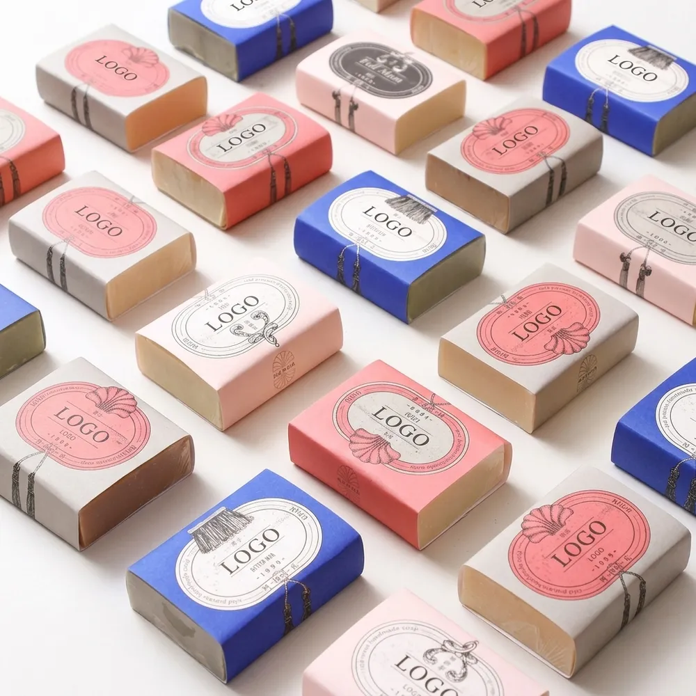 Assorted handmade soap bars wrapped in colorful custom printed paper sleeves
