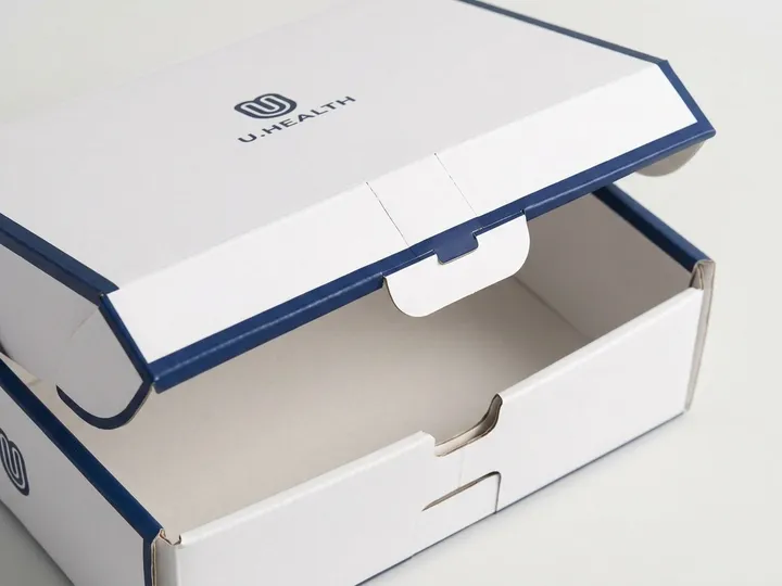 Open custom sock mailer showing front locking tab, thumb notch, lid flap, scores, and navy edge