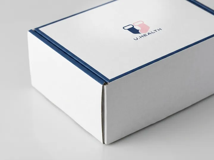 Close view of navy border printing and sock logo on a white corrugated mailer box lid