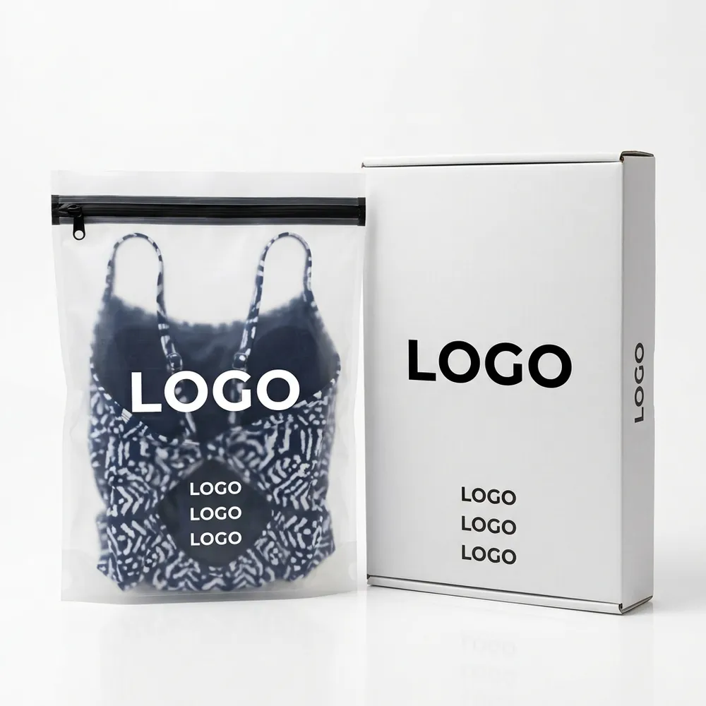 Patterned swimsuit packed in a translucent resealable pouch beside a white branded mailer box