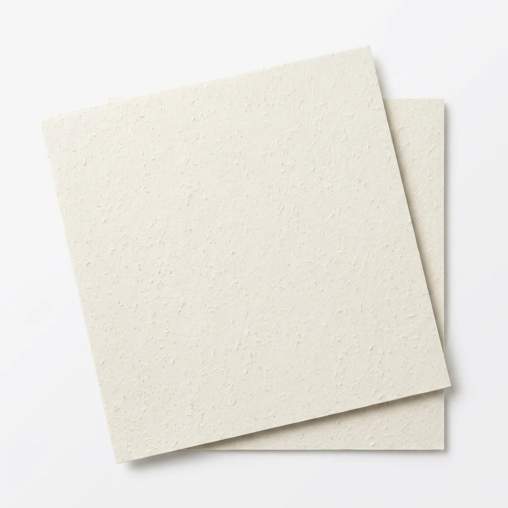 Close view of ivory textured specialty paper sheets
